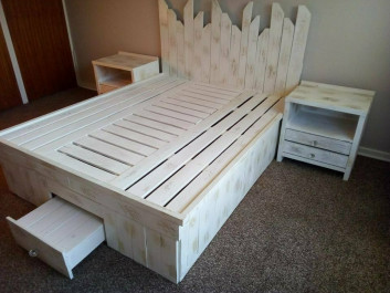 wooden pallet bed frame with storage boxes and side Table