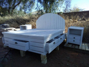 wooden pallet bed with side table